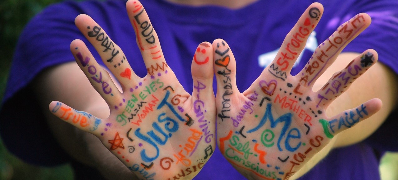 image of child holding out his palm with scribbles