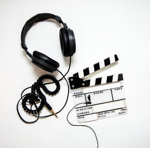 creative image of a headphone and clapboard